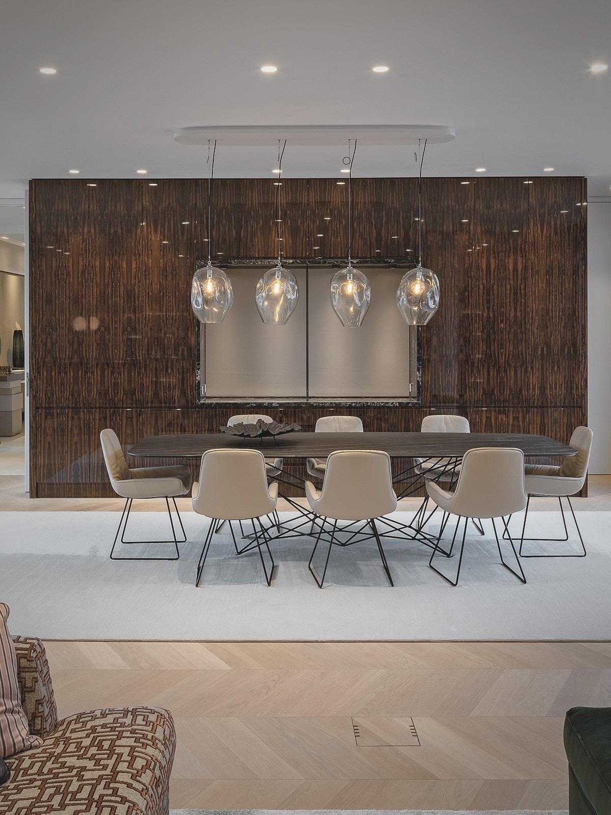 Elegantes Wohnzimmer mit großem Esstisch, Designbeleuchtung und Flügel in einer luxuriösen Wohnung am Schinkelplatz in Berlin.